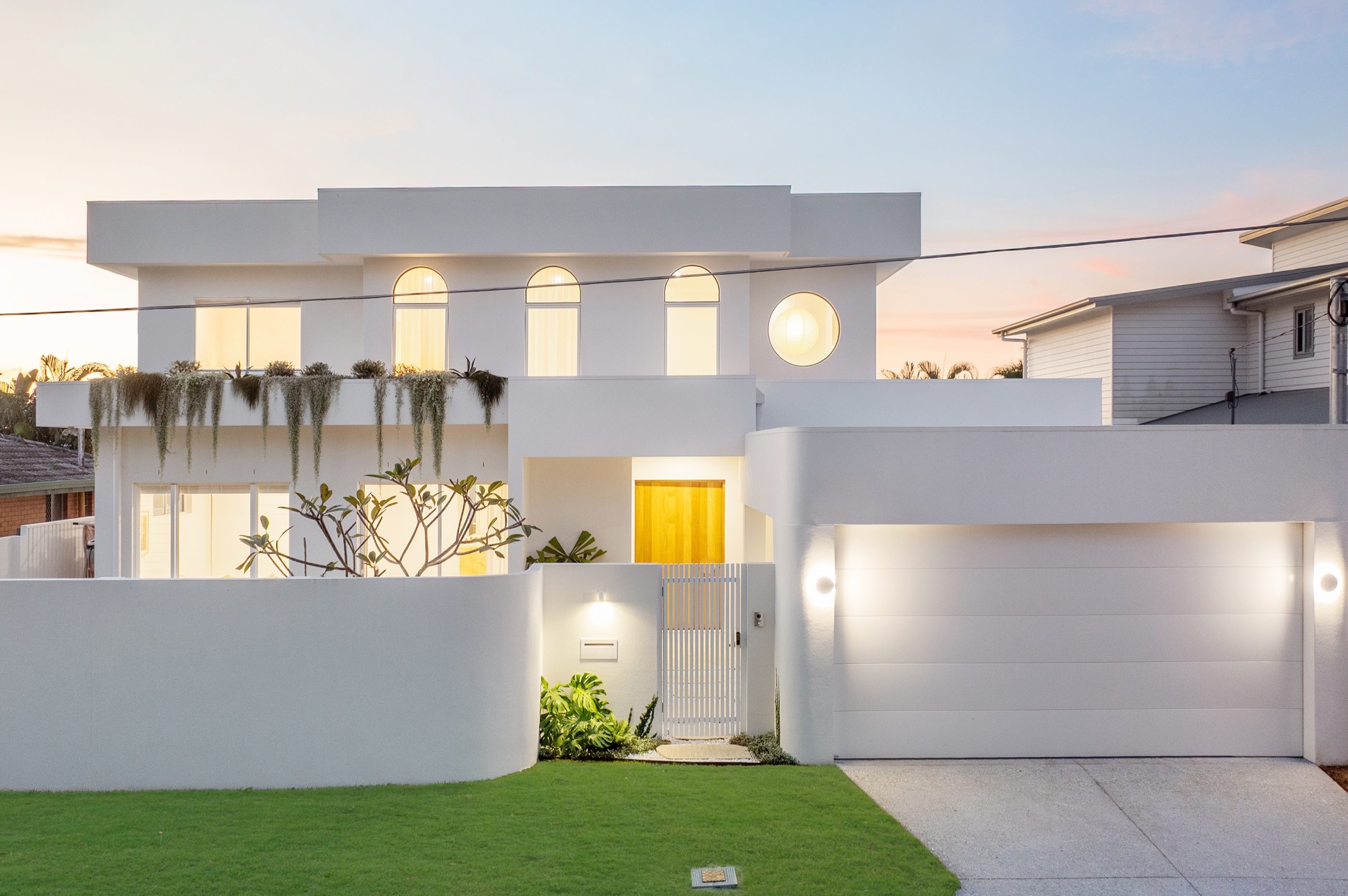 5 Iluka Street, Palm Beach, the white facade glowing at dusk