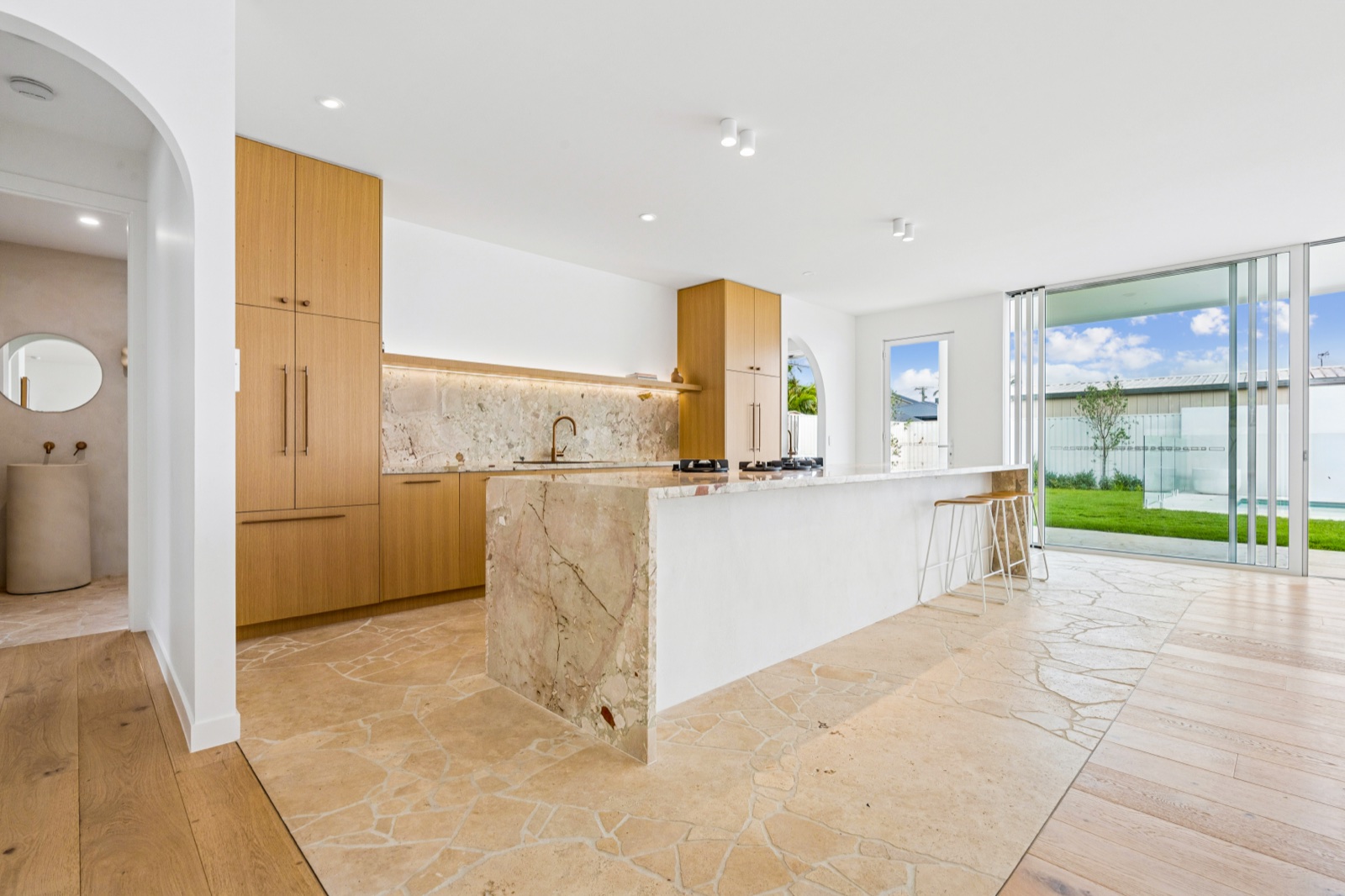Oak, stone and travertine through the kitchen and living